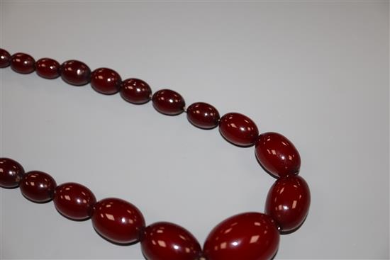 A single strand graduated simulated cherry amber bead necklace, 72cm, gross 61 grams.